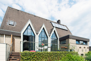  Aus einer 1980 in Hasbergen bei Osnabrück erbauten Kirche wurde ein Wohnhaus. Charakteristisch für das Gebäude sind die spitzen Kirchenfenster. Auf den ersten Blick vermutet man nicht, dass es sich dabei um eine Glas-Faltwand handelt Fotos: Solarlux / Bet 