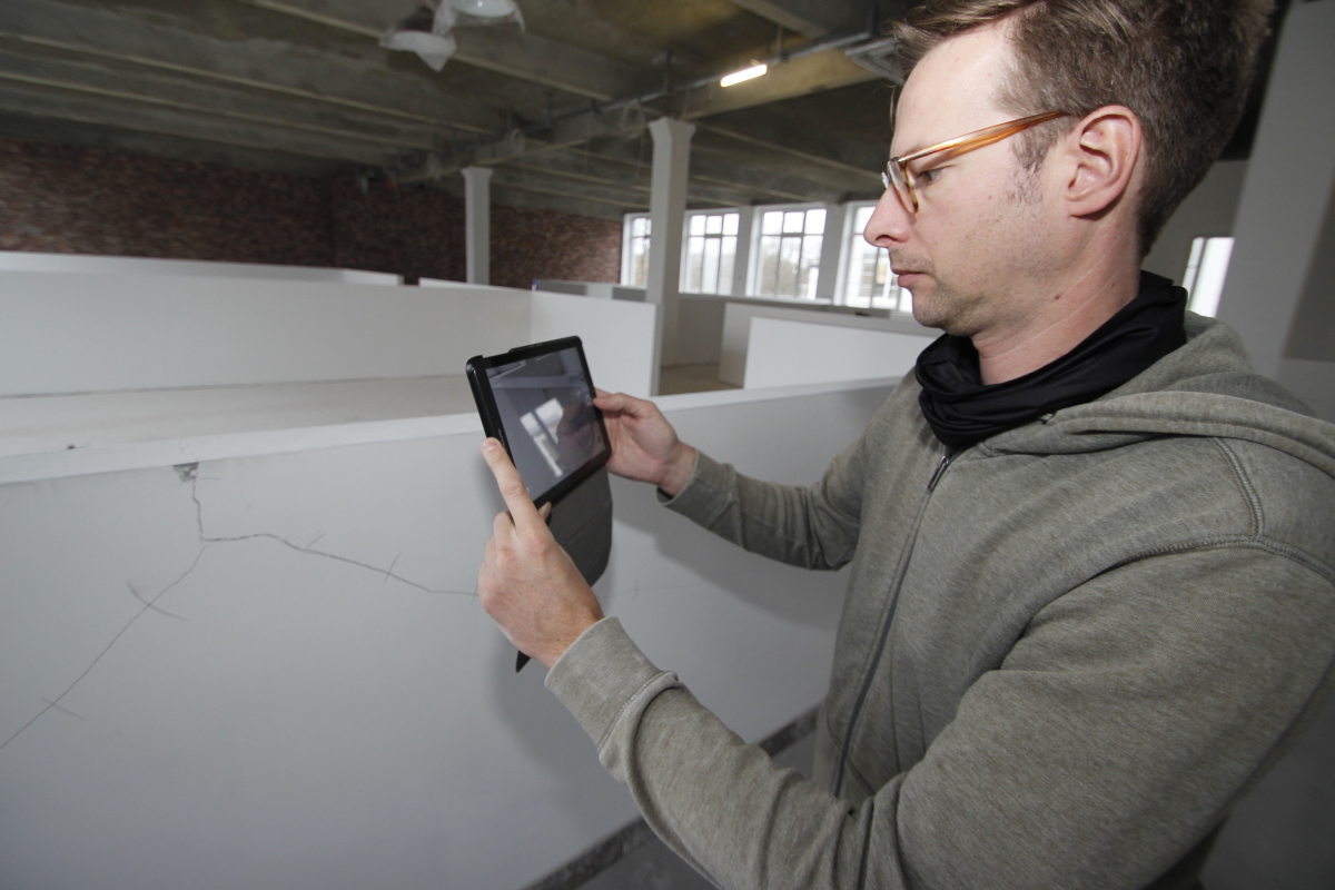 Raban Luhmer demonstriert die Dokumentation eines Risses mit einem mobilen Endgerät auf der Baustelle. Das funktioniert übrigens auch offline – was in Deutschland wegen der schlechten Netzabdeckung eine wichtige Funktion ist – problemlos. Sobald das mobil