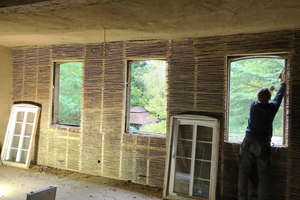  Holzkonstruktion vor dem bestehenden Fachwerk, das anschließend mit Schilfrohrmatten versehen wird. Die Matten dienen als Träger für den folgenden Lehmputz 