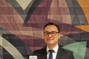  Philipp Lehmkuhl, Leiter Digitale Transformation & Unternehmensanalysen, zeigt den Deutschen Exzellenz-Preis, den Mewa erhalten hat.  