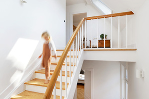  Treppenstufen und Geländer in einem hellem Holzton sowie ein zusätzliches Dachfenster – das lichtdurchflutete Treppenhaus ist kaum wiederzuerkennen 