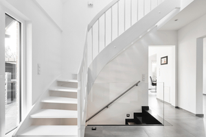  Elegante Leichtigkeit: Die weiße Treppe fügt sich optisch in den Raum ein und ist dank der schimmernden Oberflächen ein echter Hingucker 