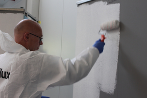  bauhandwerk-Chefredakteur Thomas Wieckhorst mit Malerrolle an der Brillux-Testwand 
