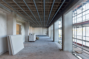  Die vorgefertigten Aluminiumrahmen wurden in die Fassadenfelder gesetzt, so dass hier die Fenster eingeschraubt werden konnten 