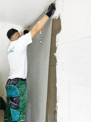 Aufbringen des Armierungsgewebes auf die ?Veinal ExsalTherm-Platten?, die Wärmedämmung und Feuchteschutz zugleich sind