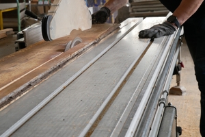  Aufarbeitung im Betrieb: Ein Tischler bearbeitet die Dielen für den erneuten Einsatz 