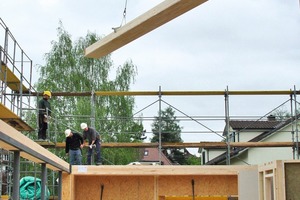  Daneben: Auf die Holzrahmenwände und das von Stahlrundstützen getragene Rähm legten die Zimmerleute die Elemente für die Massivholzdecke auf 